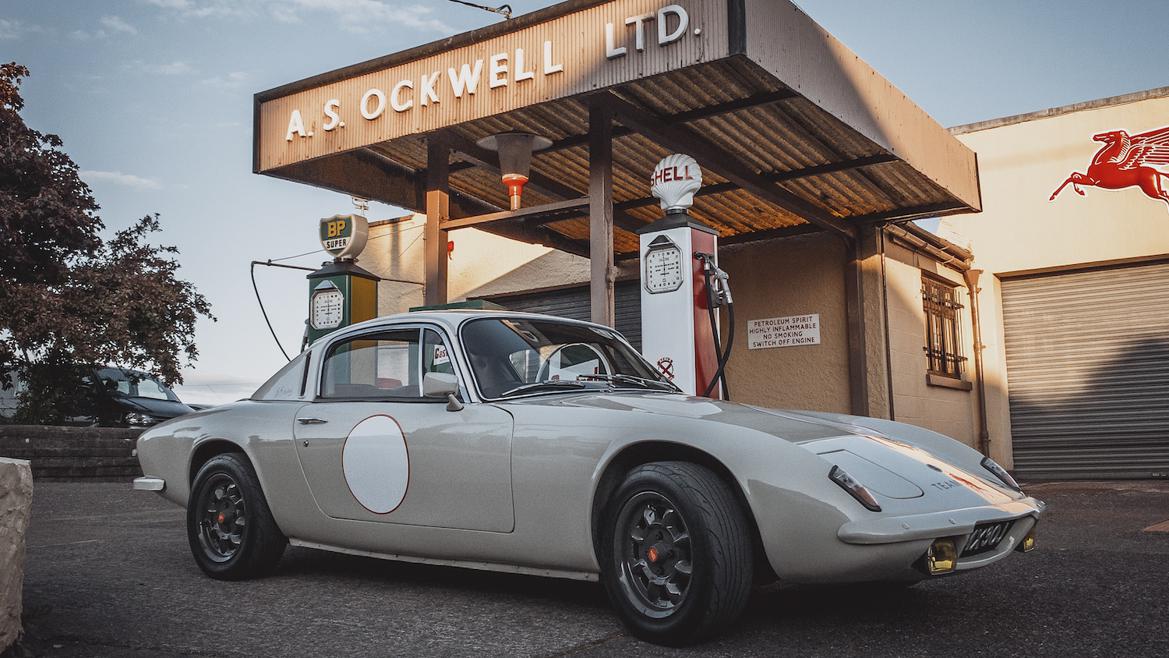 Vintage car in front of old gas station