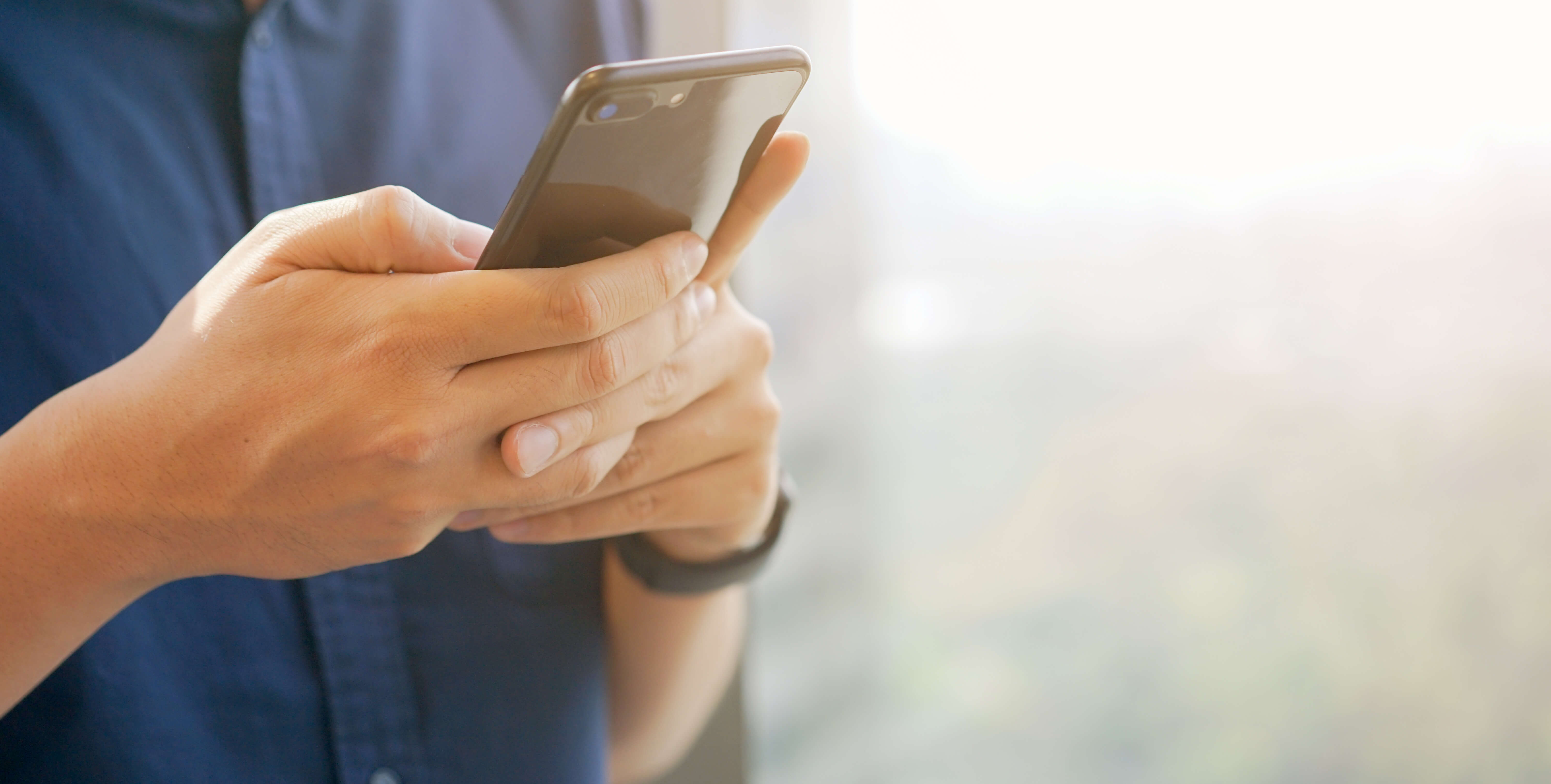 Close up businessman holding smartphone