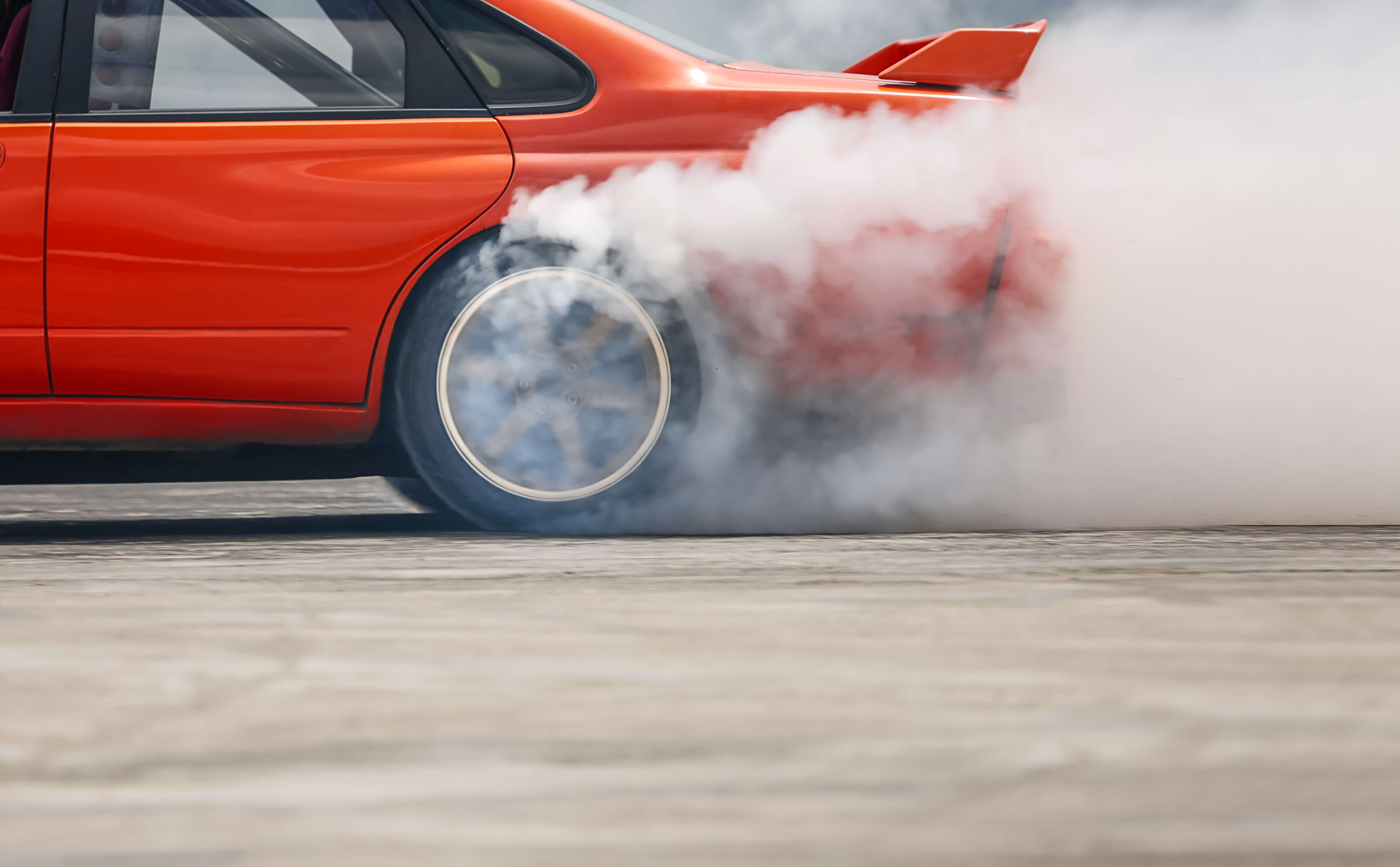 Red car burning tires