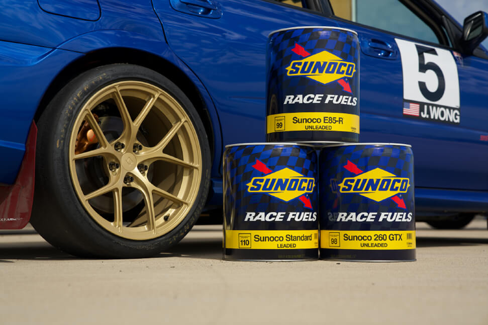 Sunoco Race Fuels cans in front of car