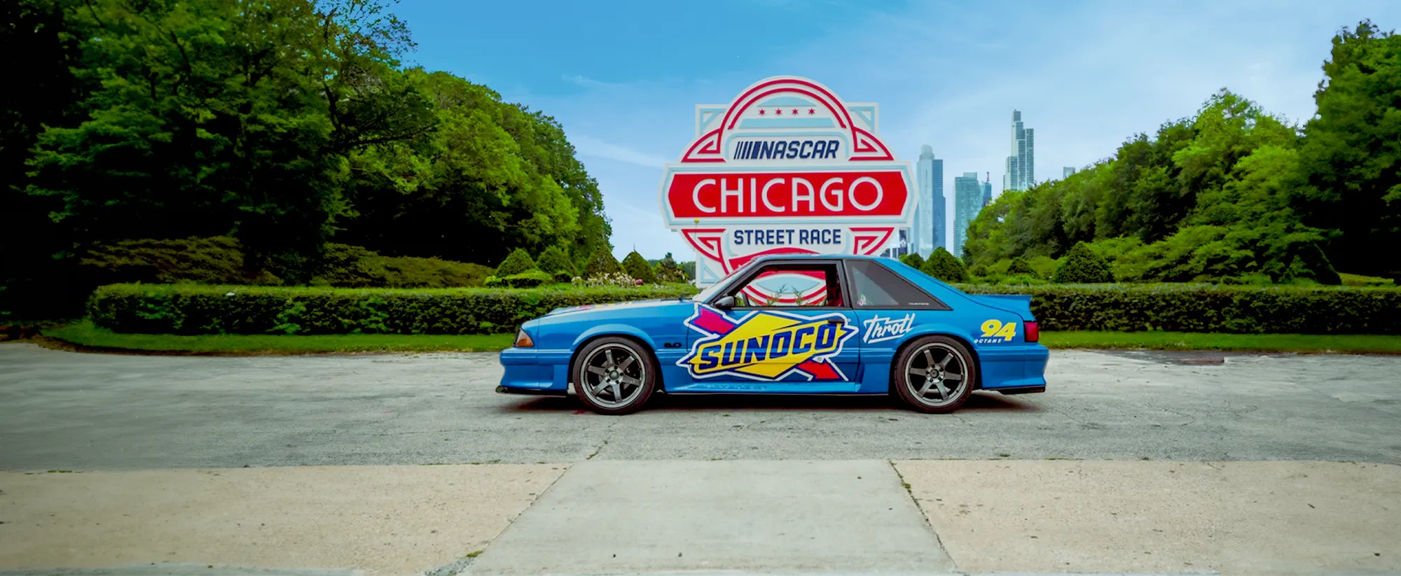 Race car in front of Chicago Street race sign