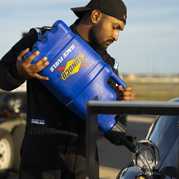 Man pouring Sunoco branded fuel into sports car